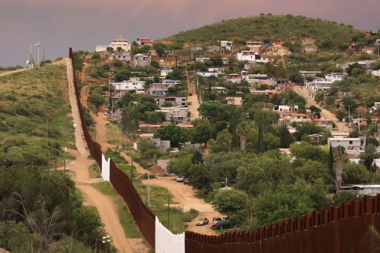 nogales, az - july 22: the u.s.-mexico border fence is seen at sunset on july 22, 2018 in nogales, arizona. on right is nogales, mexico. security cameras are seen mounted on towers over both sides of the border. president trump has proposed replacing the fence with a wall. john moore/getty images/afp== for newspapers, internet, telcos & television use only ==
