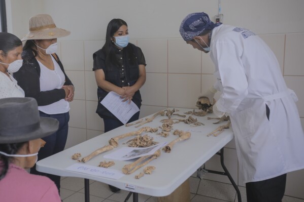 a forensic worker displays the bones of victims of peru's internal armed conflict (1980-2000) before returning them to relatives in ayacucho, peru, tuesday, oct. 22, 2024. (ap photo/silvio la rosa)