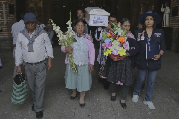 people carry the remains of relatives who were killed during peru's internal armed conflict (1980-2000) to a cemetery during a wake in ayacucho, peru, wednesday, oct. 23, 2024, the day the remains were returned to families. (ap photo/silvio la rosa)