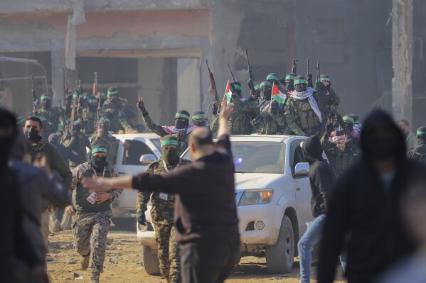 hamas fighters are greeted as they arrive in pick-up trucks to the site of the hand over of hostage agam beger to the red cross at the jabalya refugee camp in gaza city, thursday jan. 30, 2025.(ap photo/mohammed hajjar)