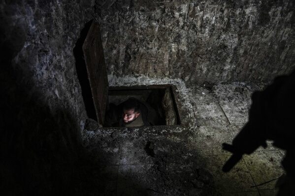 a free syrian army fighter is seen through an opening to tunnels built by the kurdish syrian democratic forces under the town of tel rifaat in the aleppo region of northern syria, tuesday, jan. 28, 2025. (ap photo/khalil hamra)