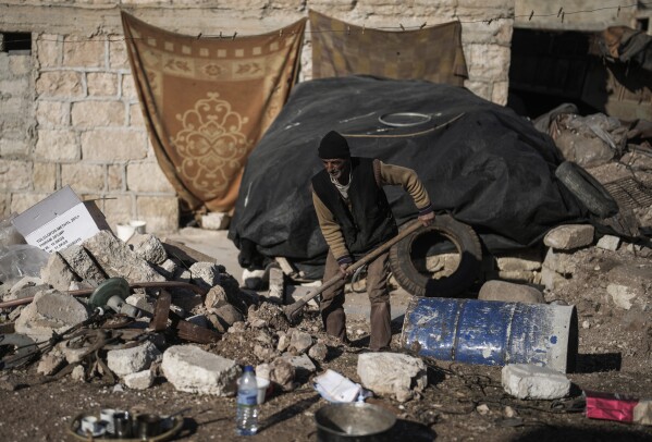 omar badran, 60, removes rubble from the backyard of his damaged home in the town of tel rifaat in the aleppo region of northern syria, tuesday, jan. 28, 2025. (ap photo/khalil hamra)