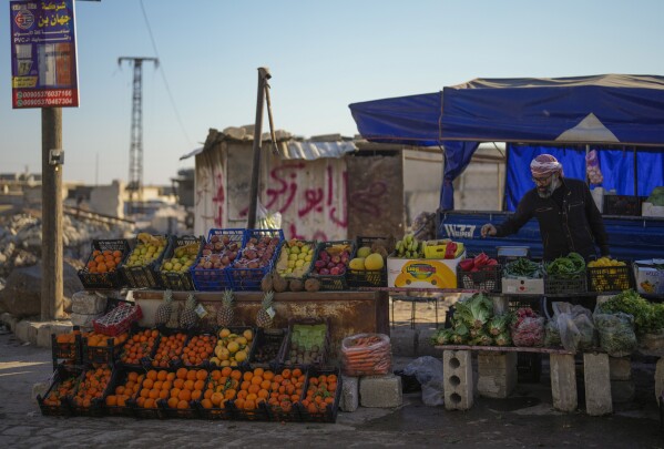 a street vendor displays fruit for sale in the town of tel rifaat in the aleppo region of northern syria, tuesday, jan. 28, 2025. (ap photo/khalil hamra)