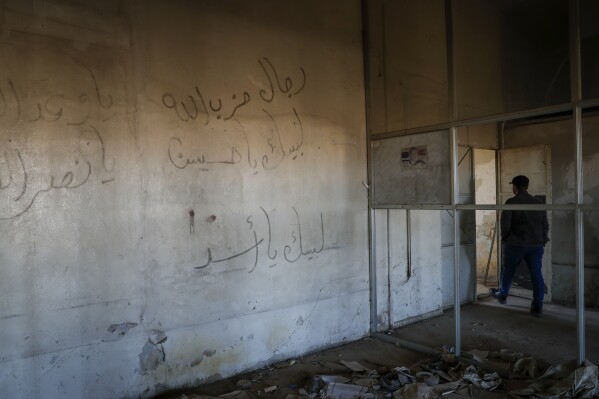 graffiti left by supporters of the assad regime is seen in the qadam train station, damaged during the war between rebel forces and ousted president bashar assad's forces, in damascus, syria, monday, jan. 13, 2025. (ap photo/omar sanadiki)